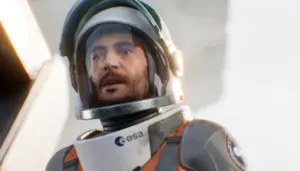 Cena cinemática de Aphelion exibindo o astronauta Thomas Cross com expressão de tensão e traje espacial com logo da ESA em destaque no peito, representando o segundo protagonista jogável da missão Hope-01 no jogo sci-fi da DON'T NOD lançado em abril de 2026.