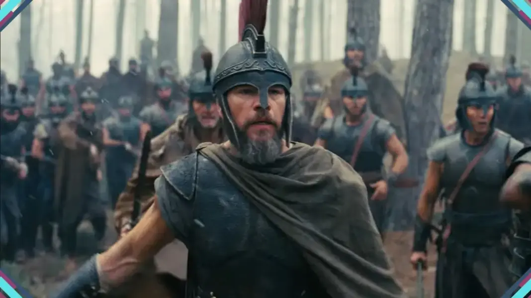 Matt Damon como Odisseu de capacete e armadura liderando guerreiros em cena do trailer de A Odisseia de Christopher Nolan