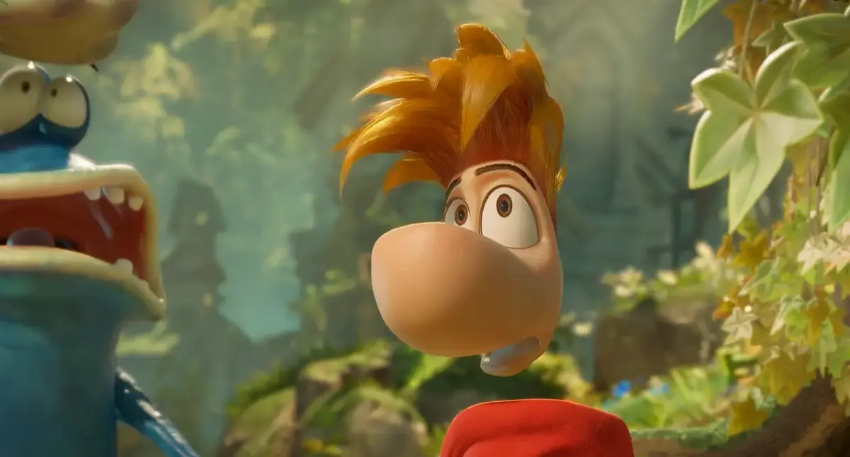 Close no rosto de Rayman com expressão curiosa em cenário de floresta em Rayman Legends Retold